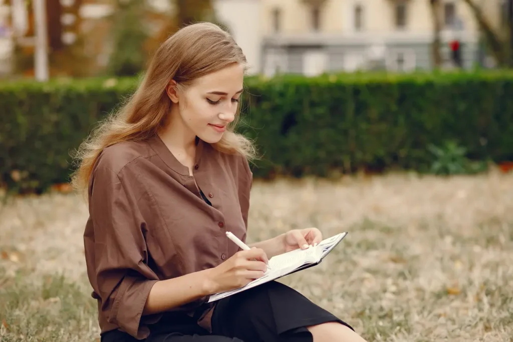 cute-student-working-park-use-notebook
