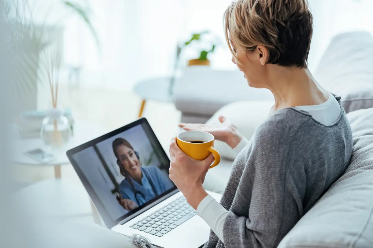 woman-using-laptop-having-video-call-with-her-doctor-while-sitting-home